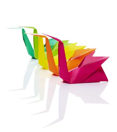 Origami swans in multiple colours in a line