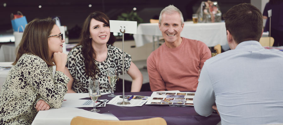 Table of people sitting down with paper on the table