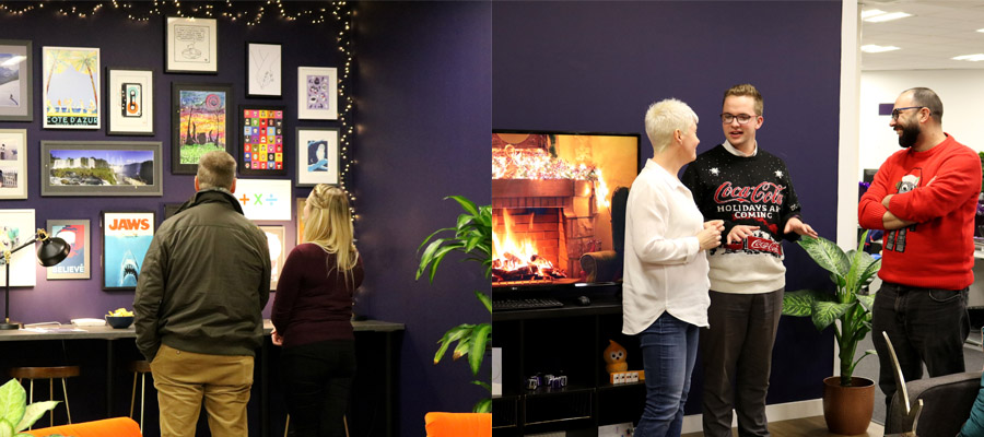 Two people standing looking at pictures on the wall