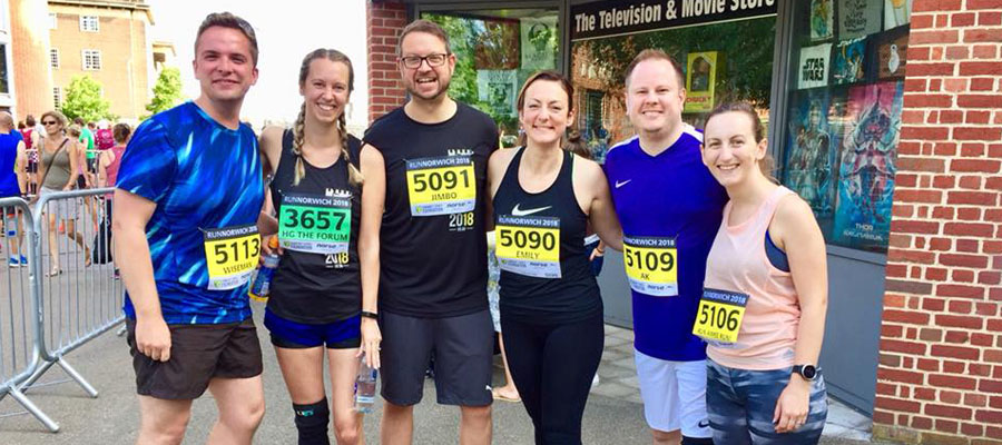 People standing in running gear with race numbers on them