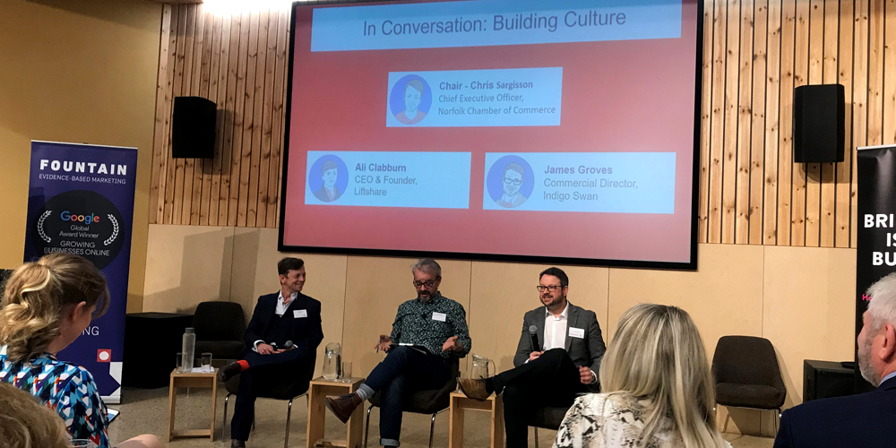 People on stage in front of projector 