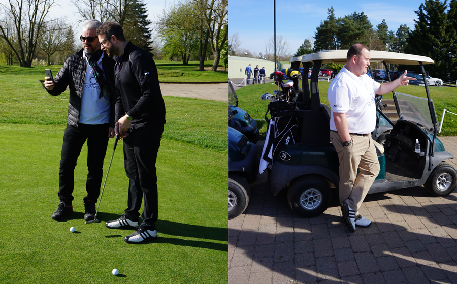 Men standing looking at phone on putting green