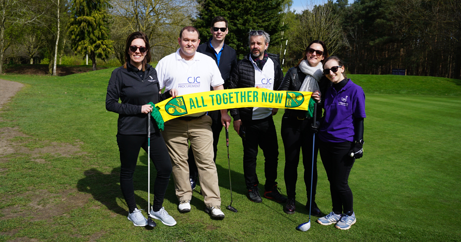 People holding up a scarf