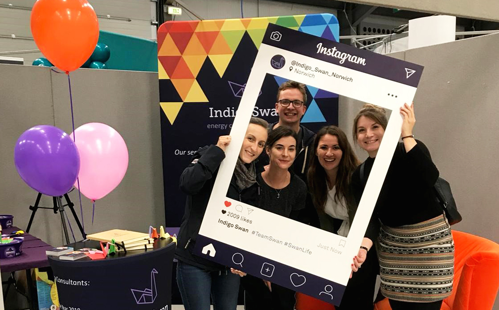 People standing holding an Instagram frame